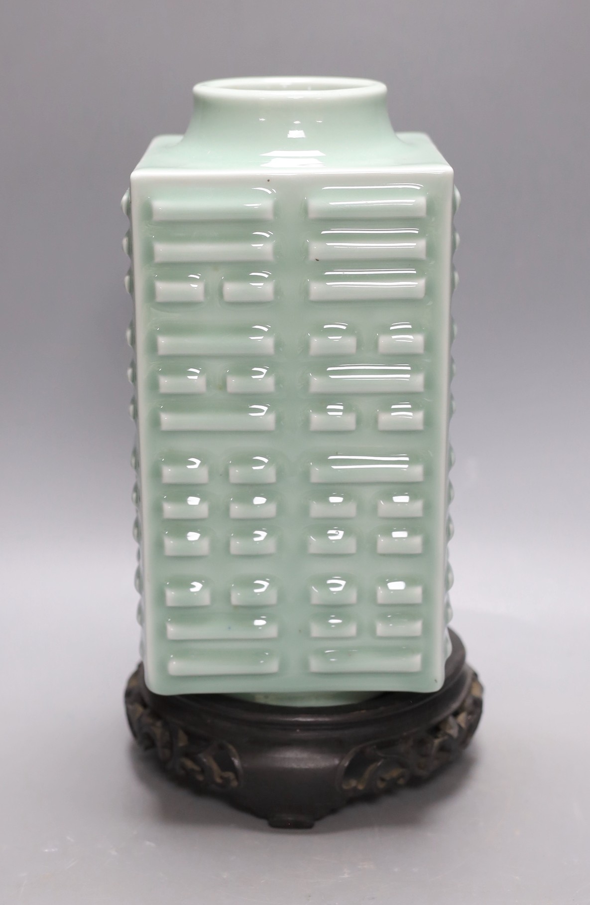 A Chinese celadon ‘eight trigrams’ vase, on stand. 32cm tall